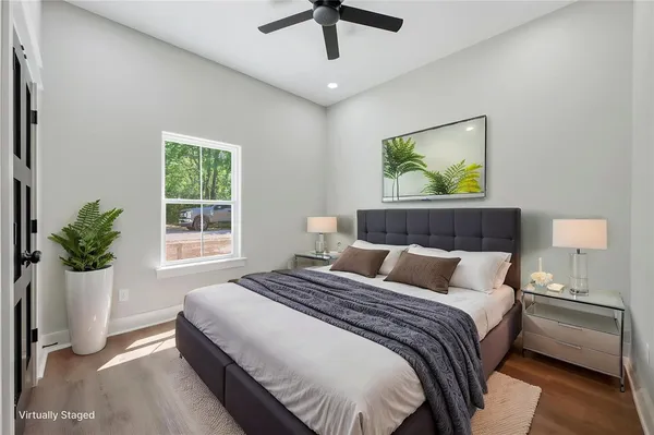 a bathroom with a granite countertop sink toilet and mirror
