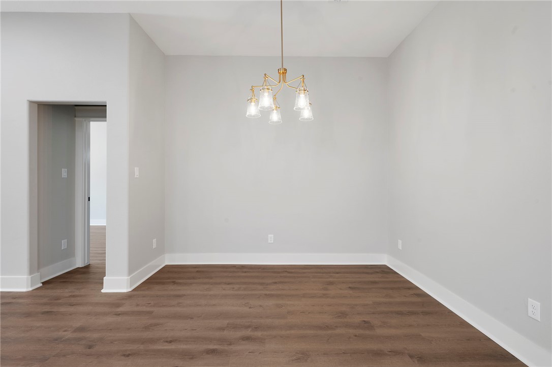 312 Morehead Street Franklin, TX 77856 - Photo 18 of 26 a view of an empty room with wooden floor and a window
