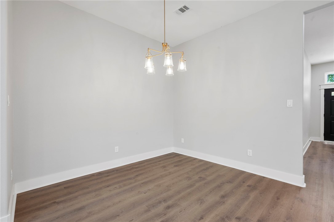 312 Morehead Street Franklin, TX 77856 - Photo 19 of 26 an empty room with wooden floor and windows