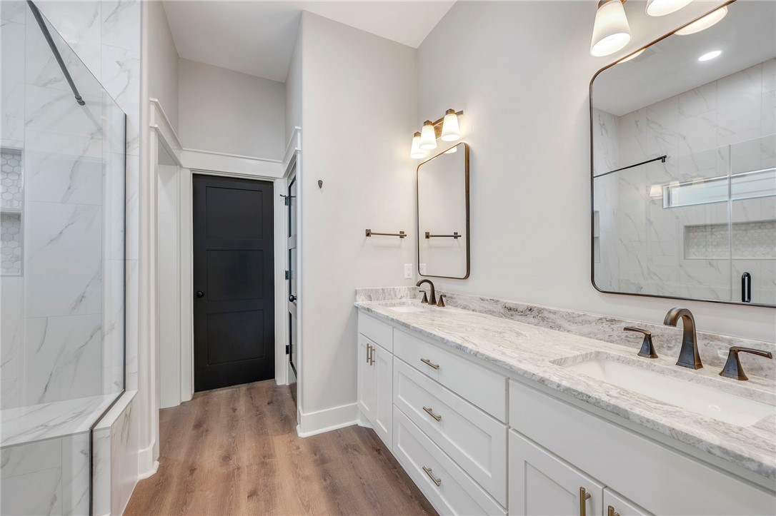 312 Morehead Street Franklin, TX 77856 - Photo 7 of 26 a bathroom with a granite countertop sink double vanity and a mirror