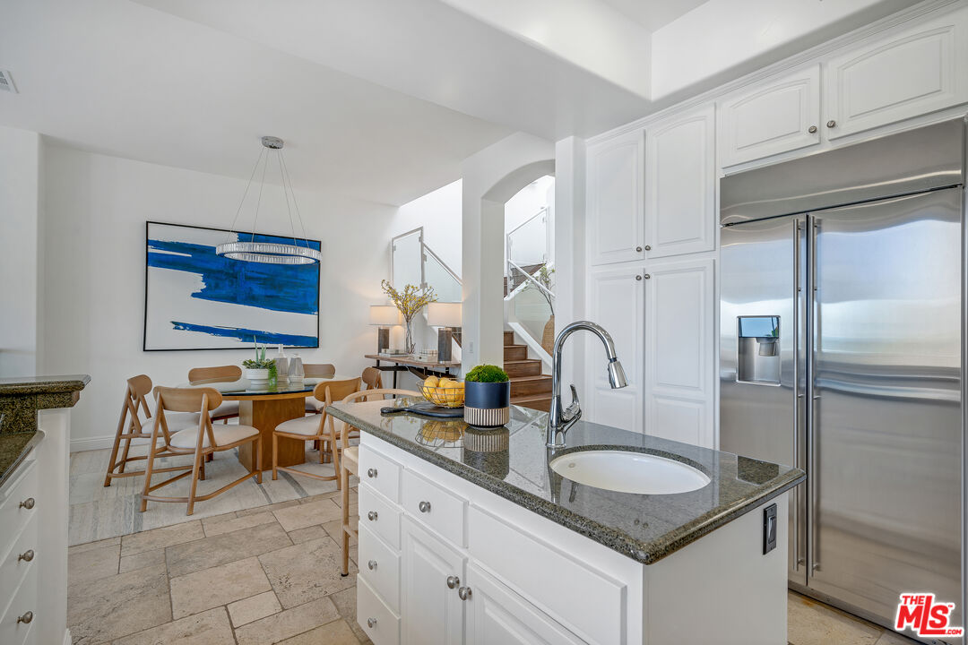 6436 Lunita Road Malibu, CA 90265 - Photo 11 of 54 a kitchen with granite countertop a sink and white cabinets