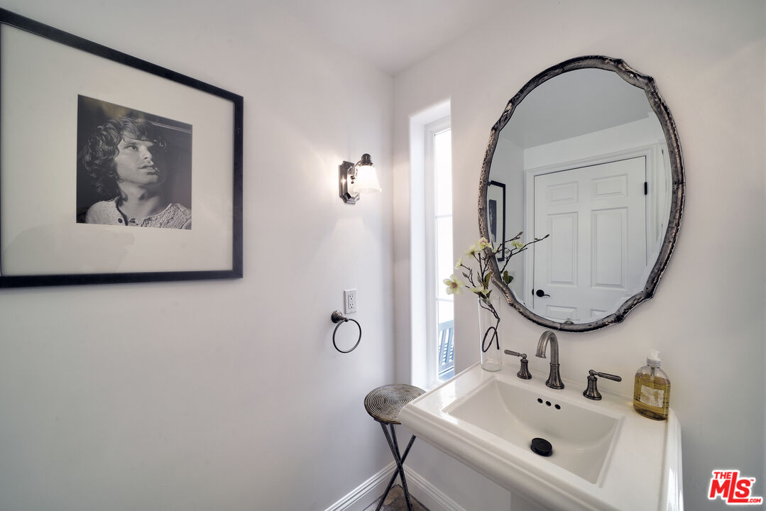 6436 Lunita Road Malibu, CA 90265 - Photo 15 of 54 a bathroom with a sink and mirror