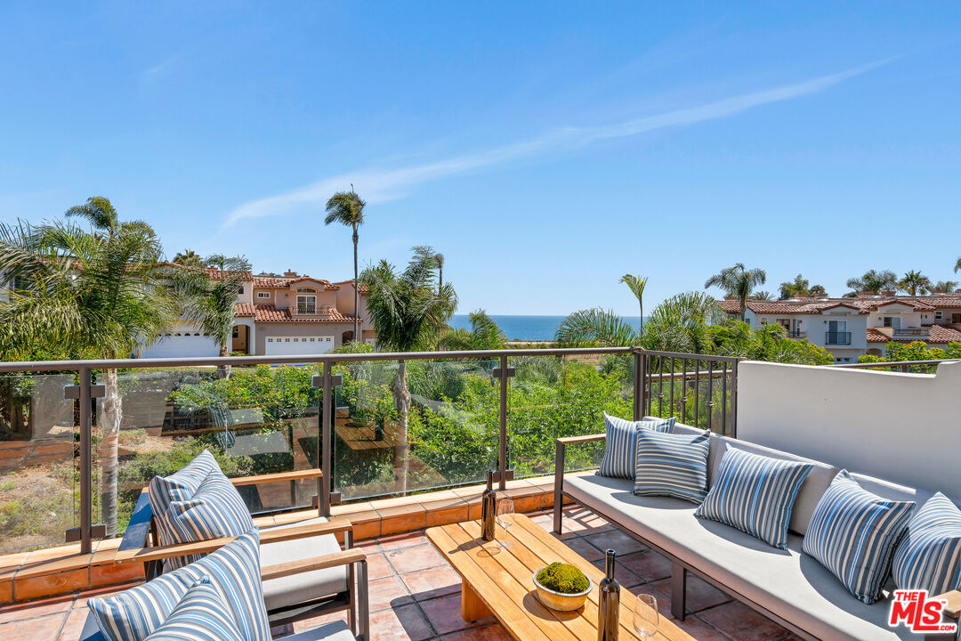 6436 Lunita Road Malibu, CA 90265 - Photo 16 of 54 a view of a balcony with lake view and a potted plant