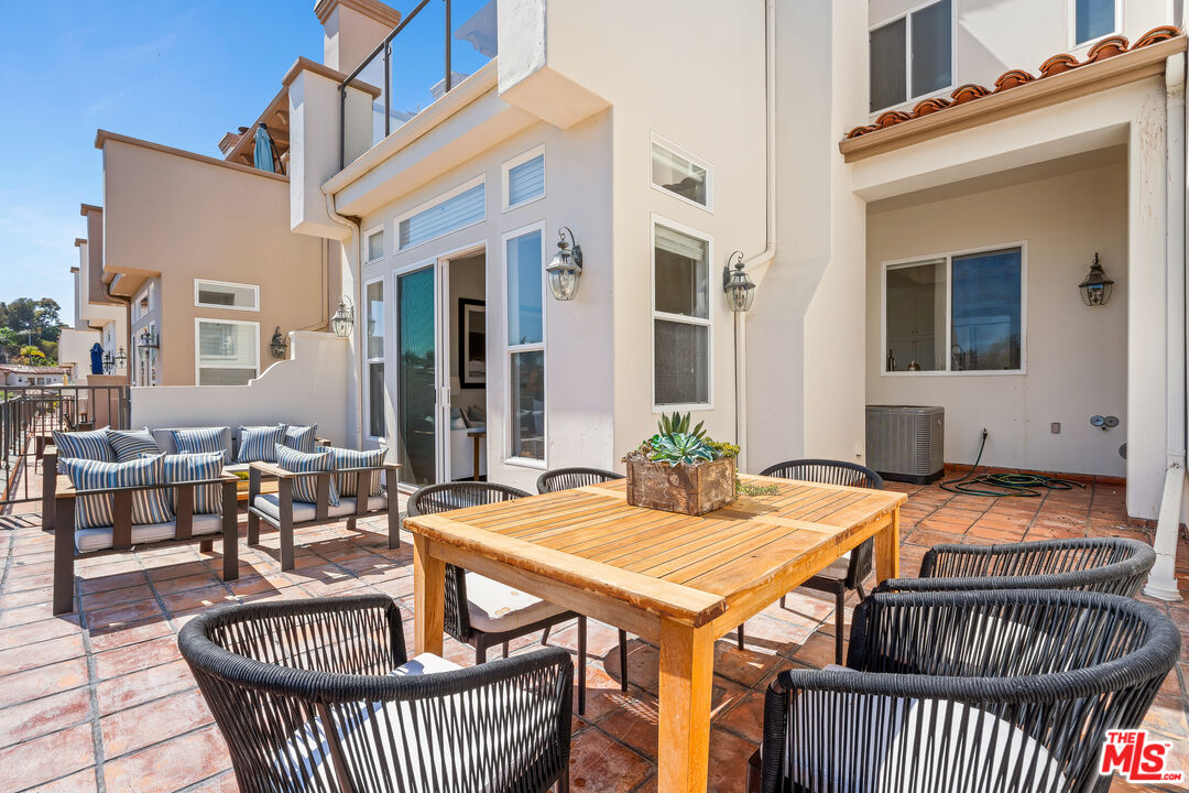 6436 Lunita Road Malibu, CA 90265 - Photo 20 of 54 a balcony with table and chairs and wooden floor