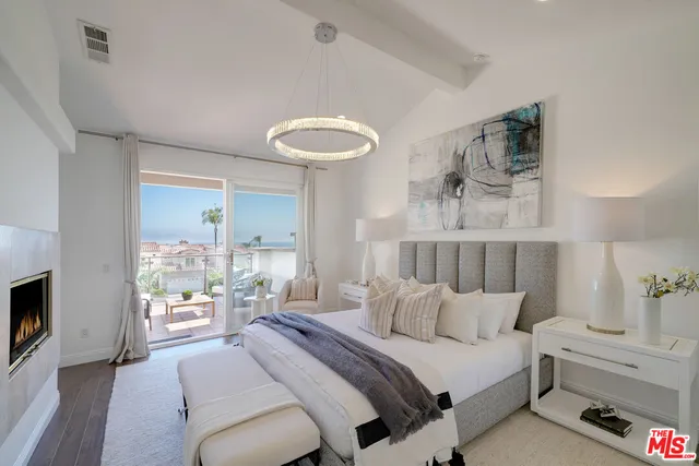 a bedroom with furniture and a view of chandelier