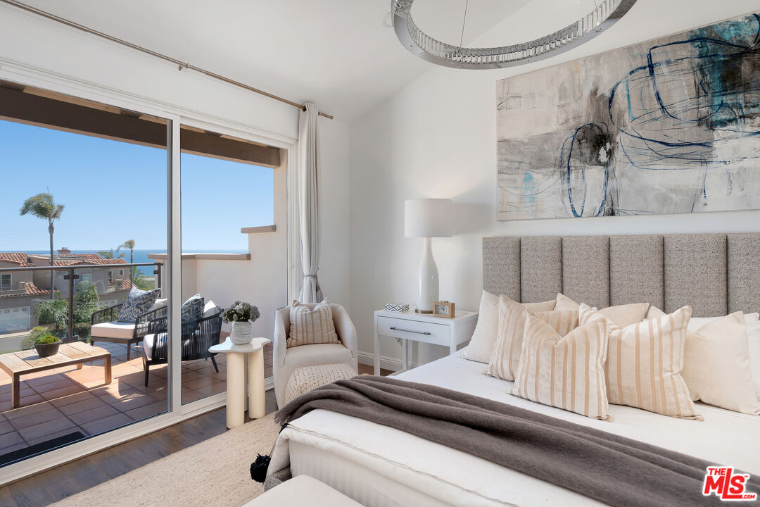 6436 Lunita Road Malibu, CA 90265 - Photo 25 of 54 a bedroom with furniture and a view of chandelier