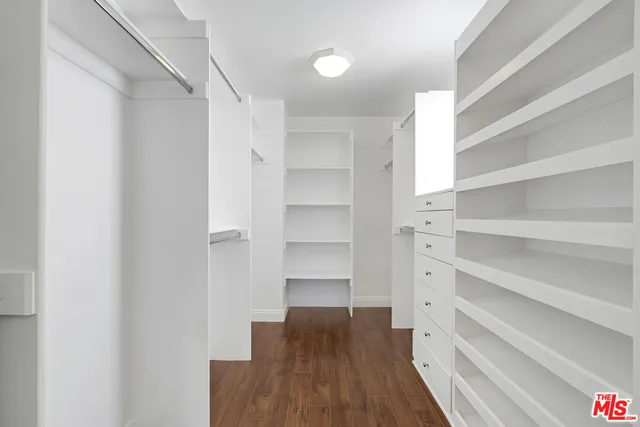 a bathroom with a tub a sink shower and mirror