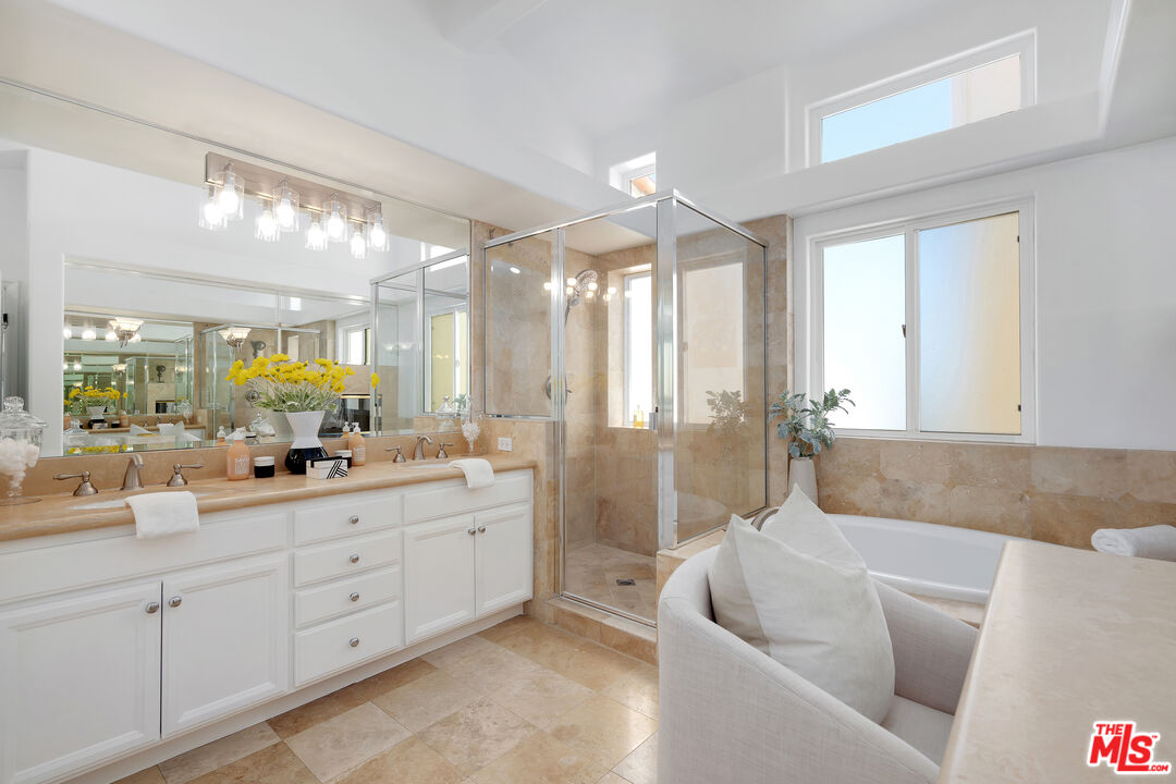 6436 Lunita Road Malibu, CA 90265 - Photo 28 of 54 a spacious bathroom with double vanity a mirror a bathtub and shower