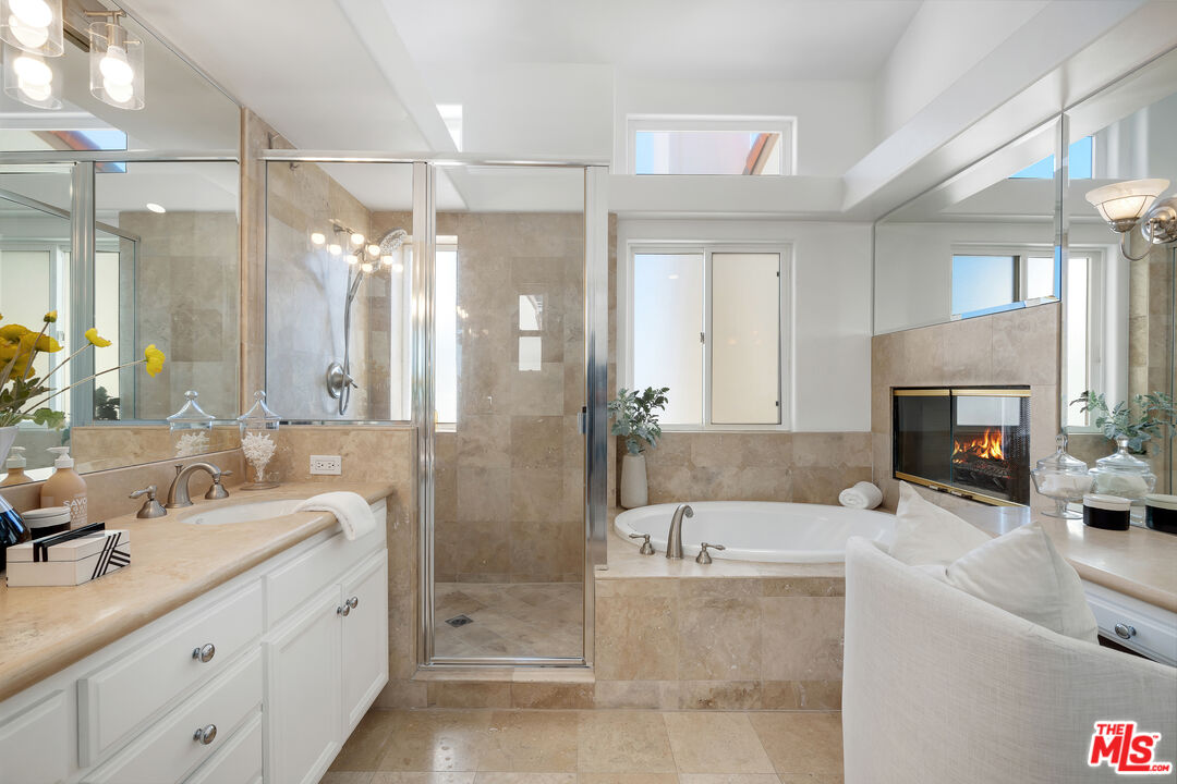 6436 Lunita Road Malibu, CA 90265 - Photo 30 of 54 a bathroom with a tub a sink shower and mirror