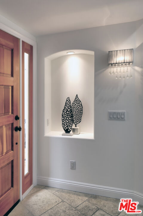 6436 Lunita Road Malibu, CA 90265 - Photo 3 of 54 a room with a table and a potted plant