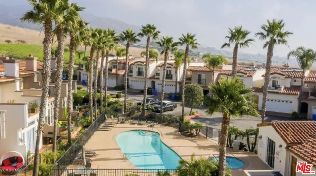 a living room with furniture and a large window with outer view