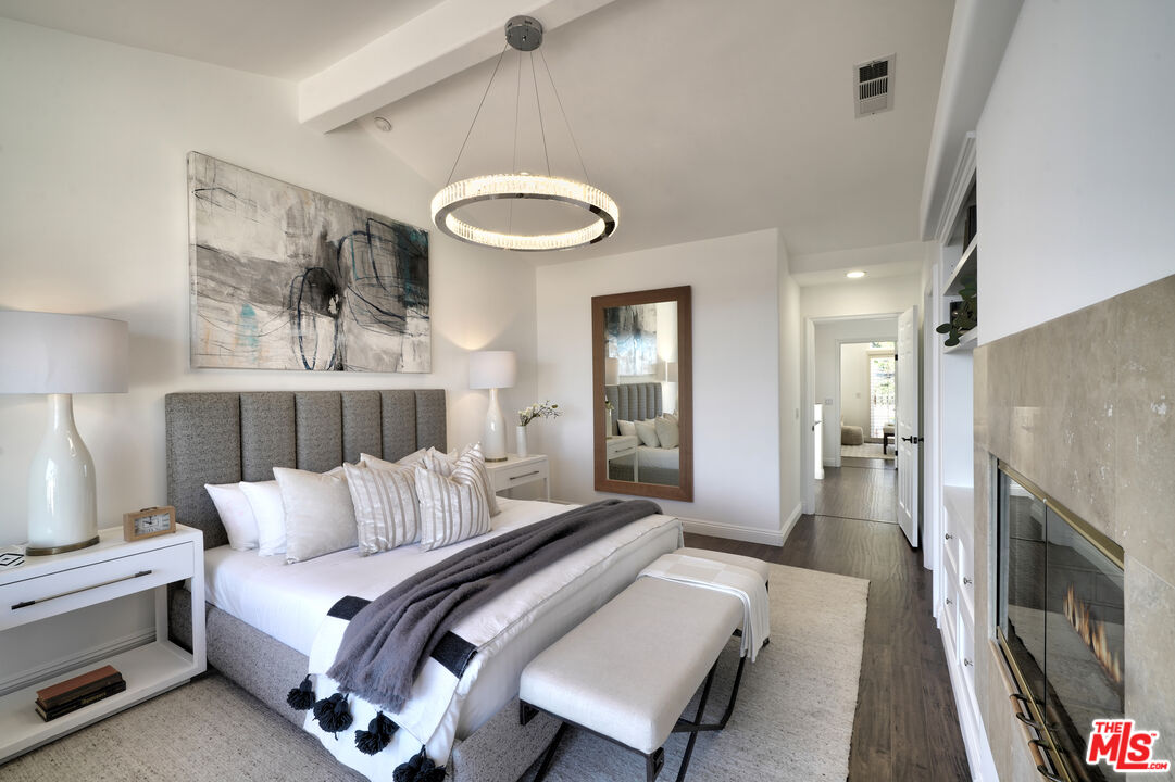 6436 Lunita Road Malibu, CA 90265 - Photo 48 of 54 a bedroom with a bed and a fireplace