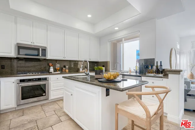 a kitchen with a sink a stove a refrigerator and cabinets