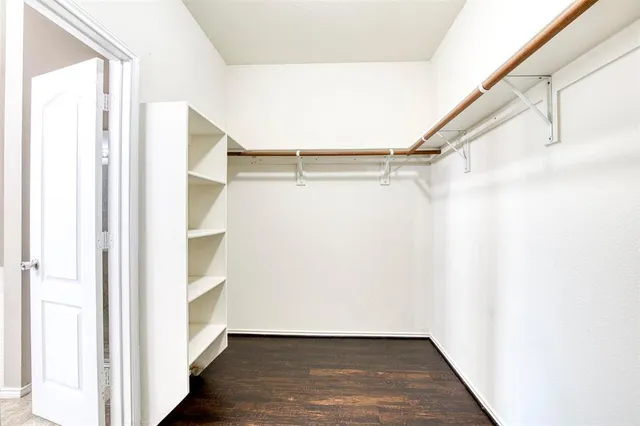 a view of walk in closet with empty racks