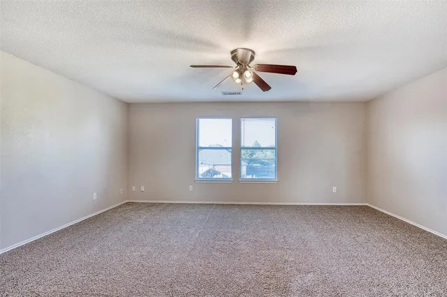 a view of room with a ceiling fan and window