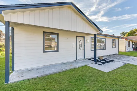 a backyard of a house with table and chairs