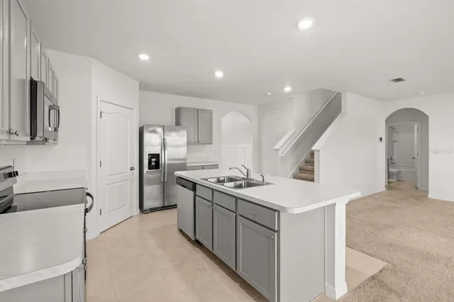 a kitchen with stainless steel appliances a sink stove and microwave