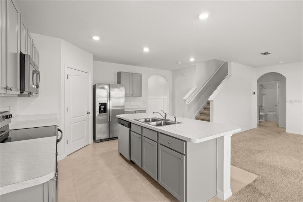 307 Sunset View Drive Edgewater, FL 32141 - Photo 13 of 44 a kitchen with stainless steel appliances granite countertop a sink stove and refrigerator