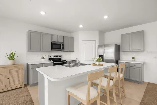 a living room with furniture and a view of kitchen