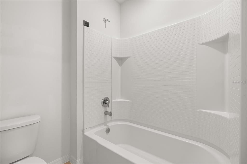 307 Sunset View Drive Edgewater, FL 32141 - Photo 31 of 44 a white bath tub sitting next to a white toilet and vanity