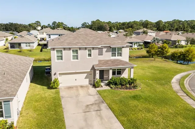 an aerial view of residential house with outdoor space and swimming pool