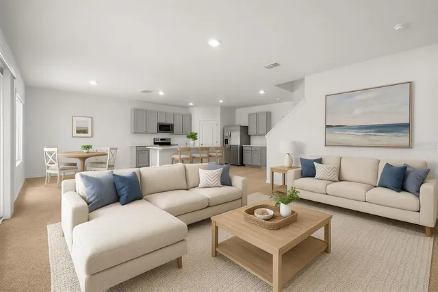 a view of a dining room with furniture a chandelier and wooden floor