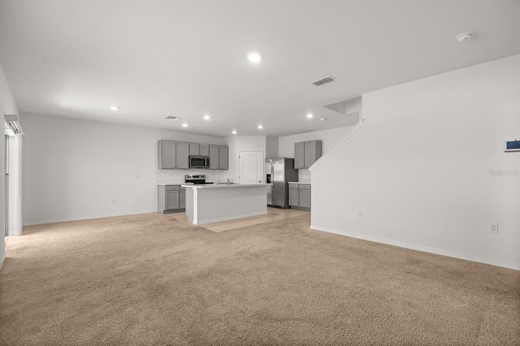 307 Sunset View Drive Edgewater, FL 32141 - Photo 10 of 44 a view of kitchen with refrigerator and white cabinets