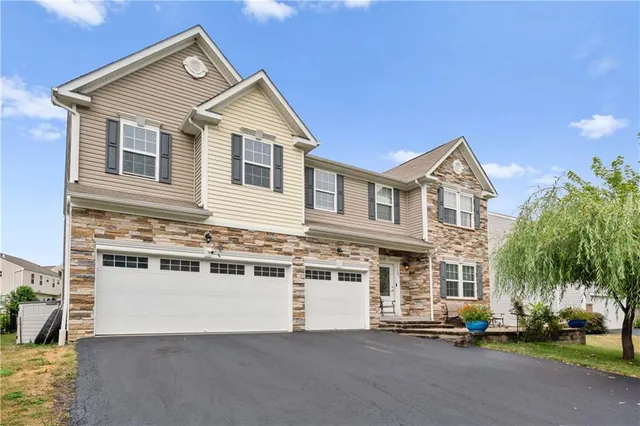 a view of a white house next to a yard with palm trees
