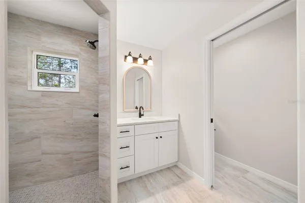 a spacious bathroom with a double vanity sink and a mirror