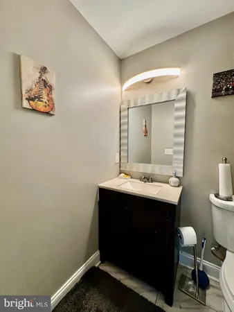 a bathroom with a sink mirror and toilet