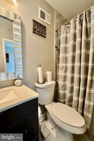 a white toilet sitting next to a bathroom sink
