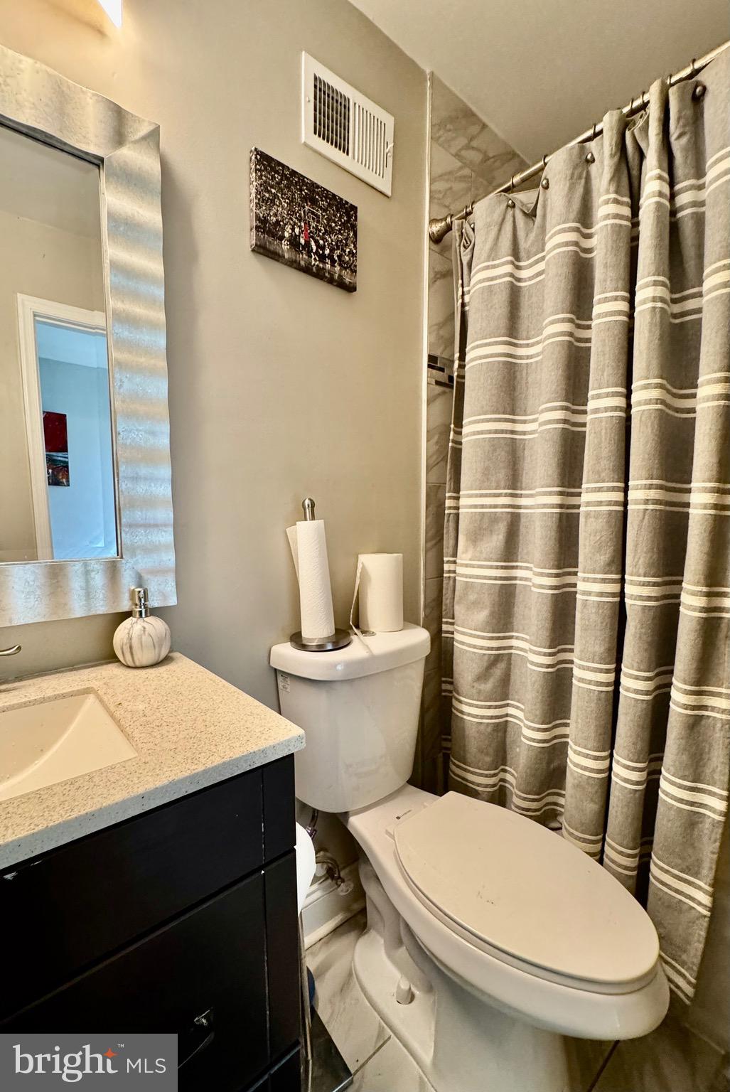 1019 West Fayette Street Baltimore, MD 21223 - Photo 14 of 29 a white toilet sitting next to a bathroom sink