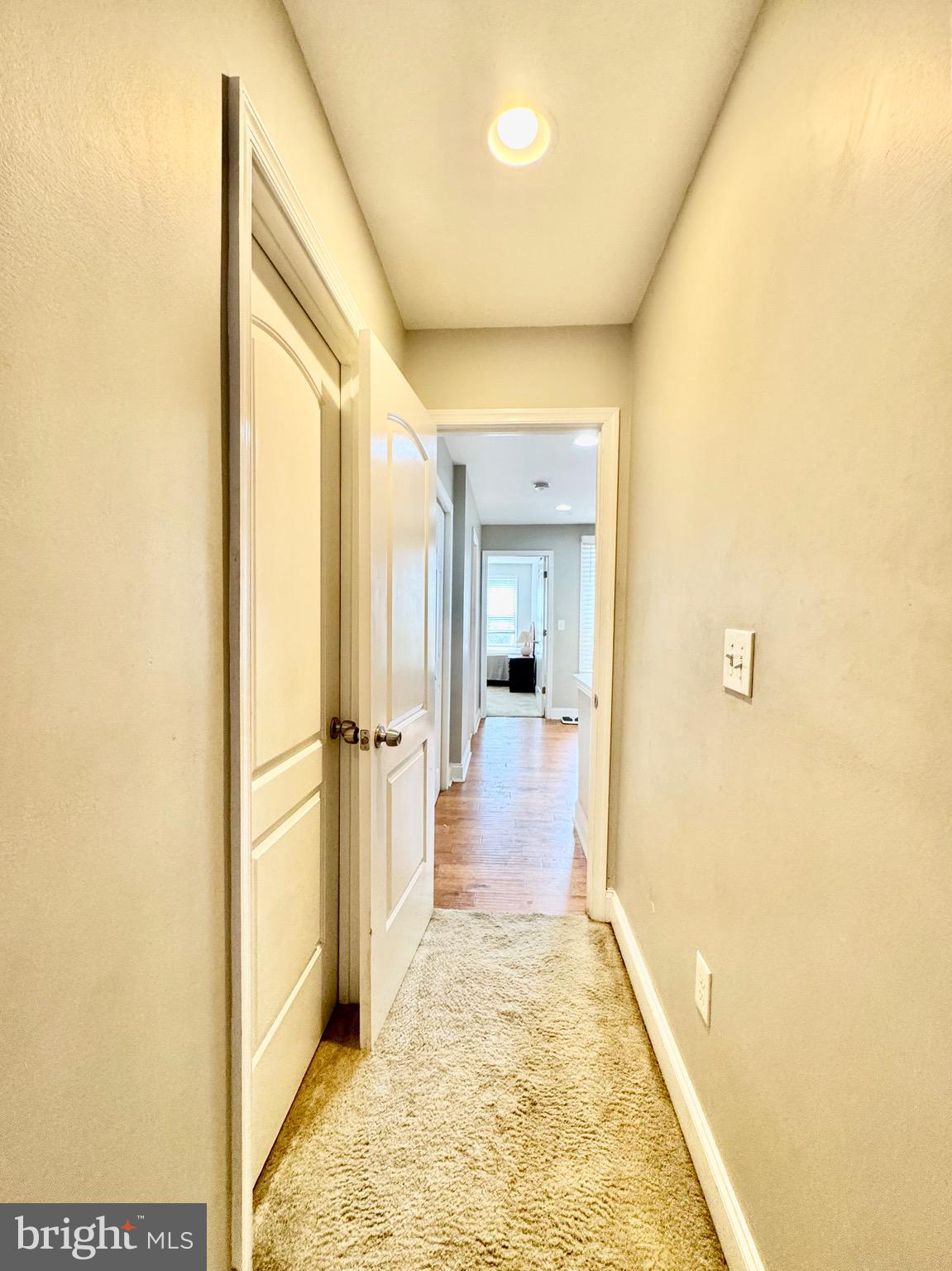 1019 West Fayette Street Baltimore, MD 21223 - Photo 18 of 29 a view of a hallway with wooden floor and a living room