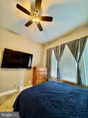 a bedroom with a bed and a television