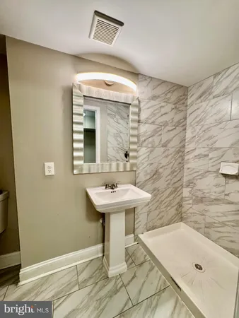 a bathroom with a sink a mirror and a bathtub