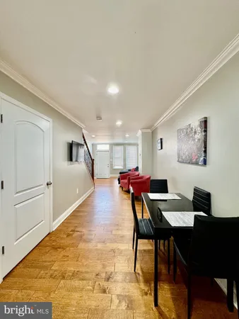 a dining room with wooden floor and breakfast area