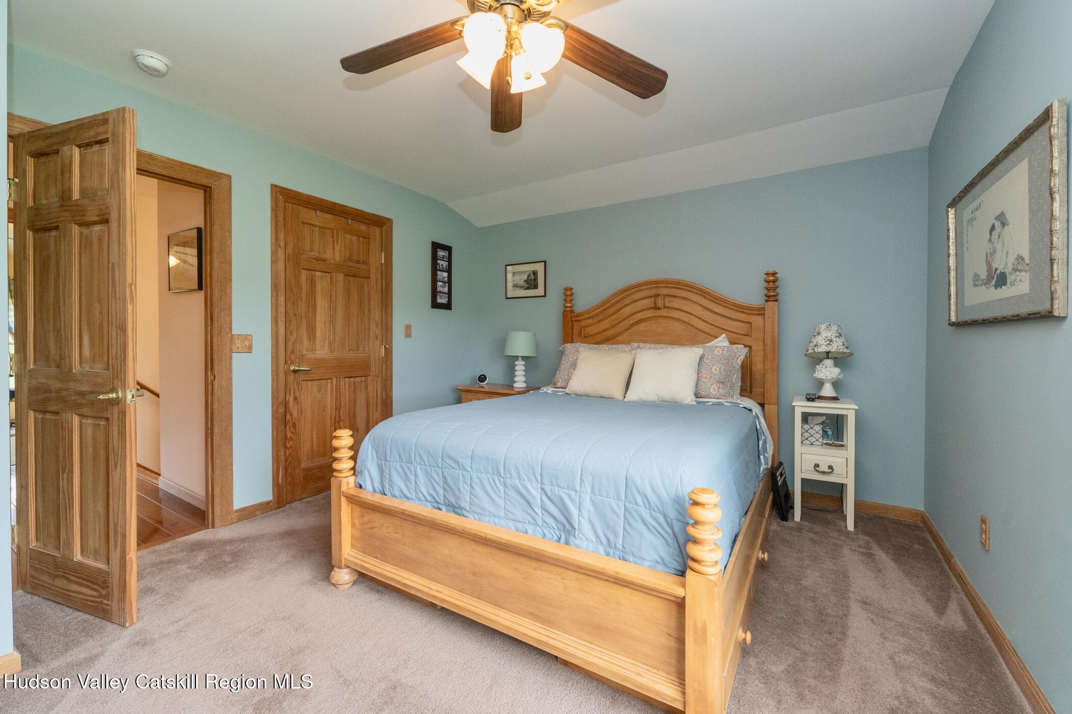 140 Stone Dock Road High Falls, NY 12440 - Photo 23 of 42 a bedroom with a bed and a chandelier