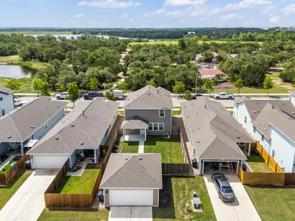 an aerial view of multiple houses with a yard