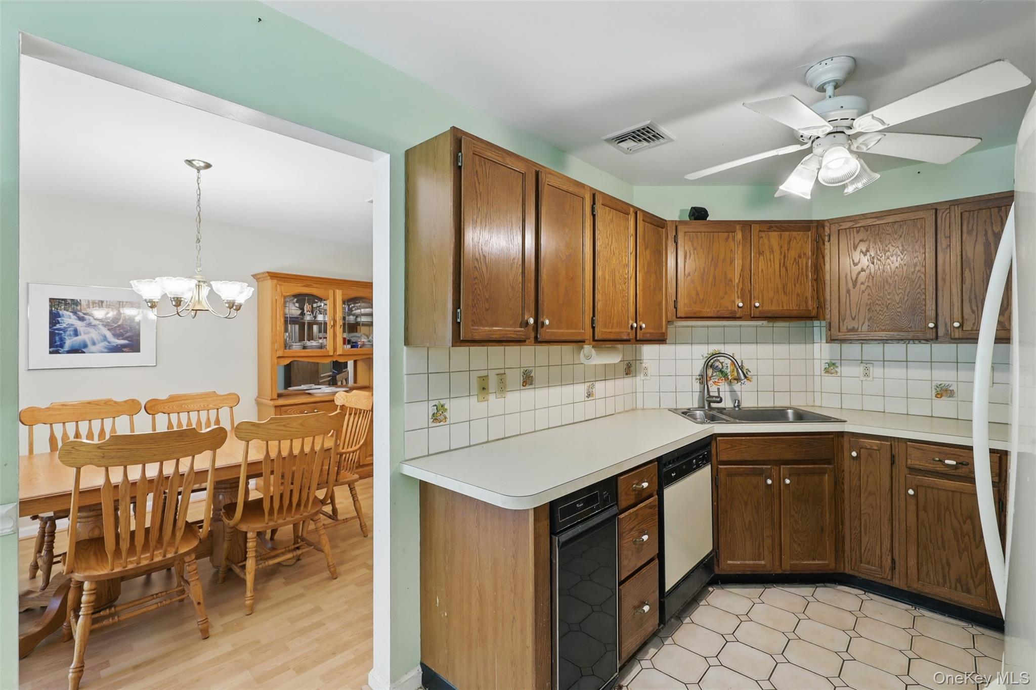 21 Lamplight Street Beacon, NY 12508 - Photo 11 of 26 a kitchen with a sink counter top space appliances and cabinets