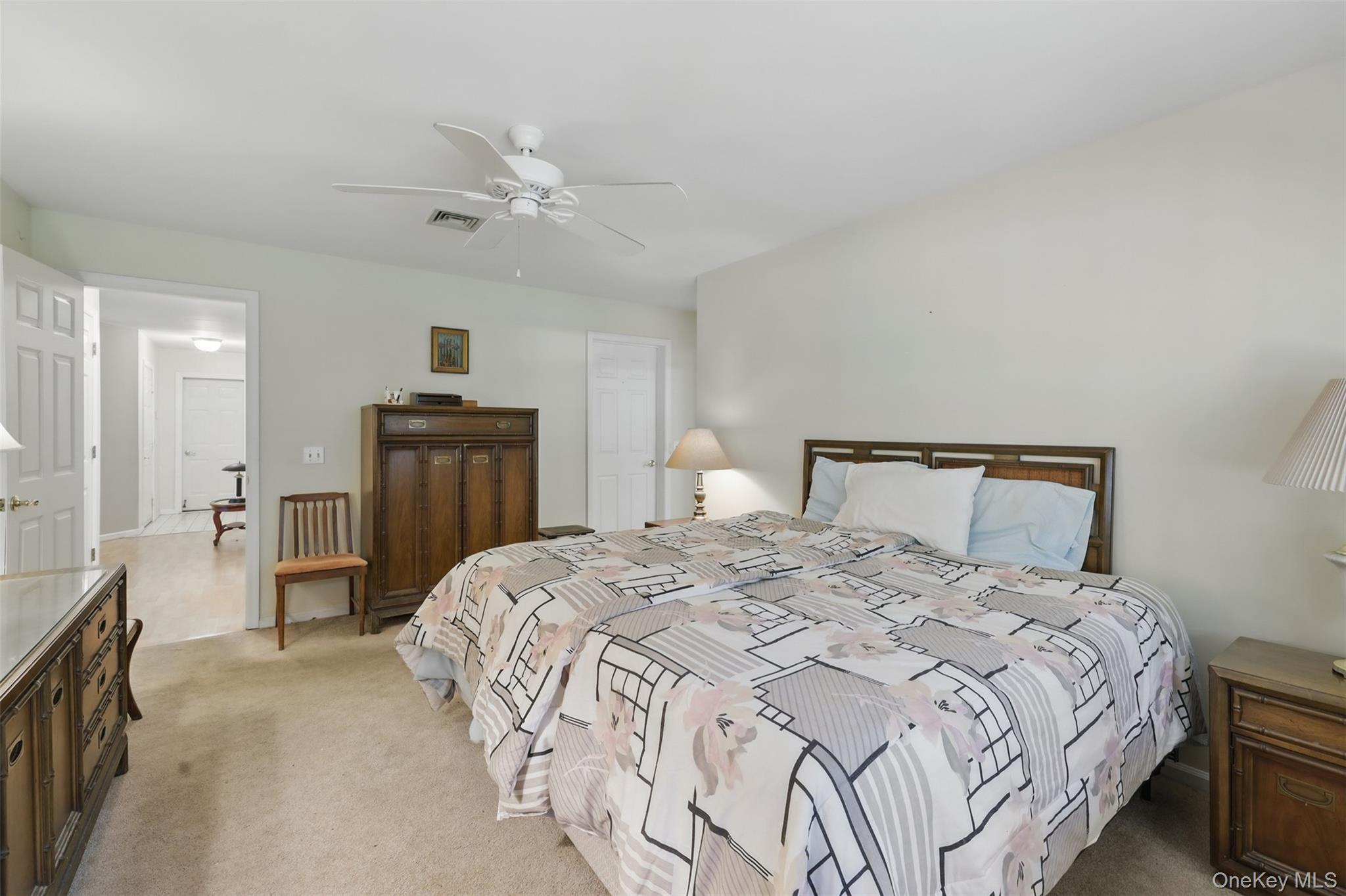21 Lamplight Street Beacon, NY 12508 - Photo 15 of 26 a bedroom with a bed and a chandelier
