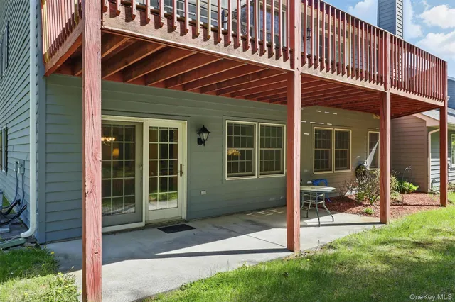a front view of a house with a large window and a yard
