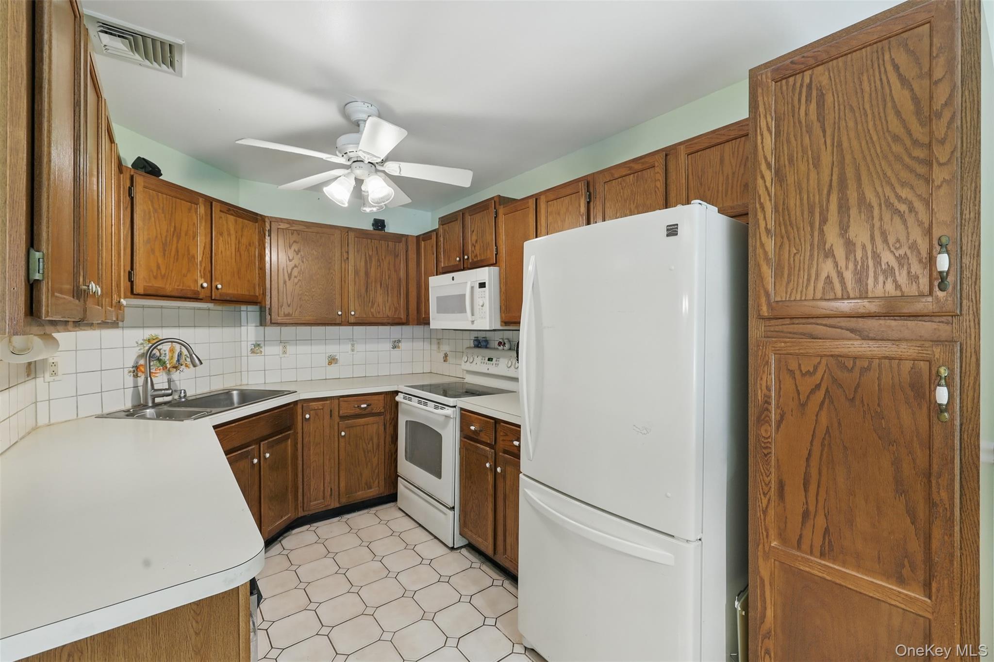 21 Lamplight Street Beacon, NY 12508 - Photo 9 of 26 a white refrigerator freezer sitting inside of a kitchen