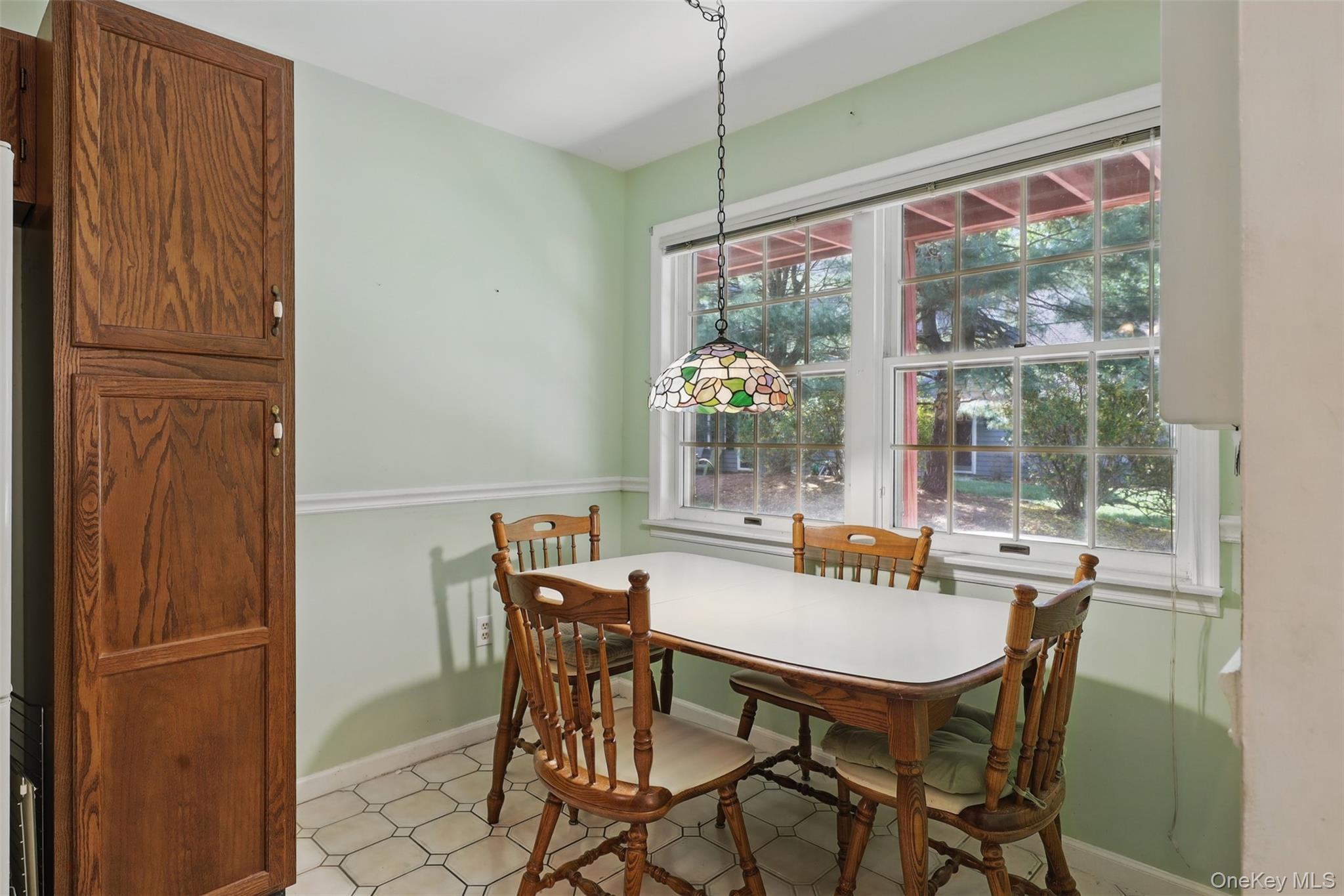 21 Lamplight Street Beacon, NY 12508 - Photo 10 of 26 a dining room with furniture a chandelier and window