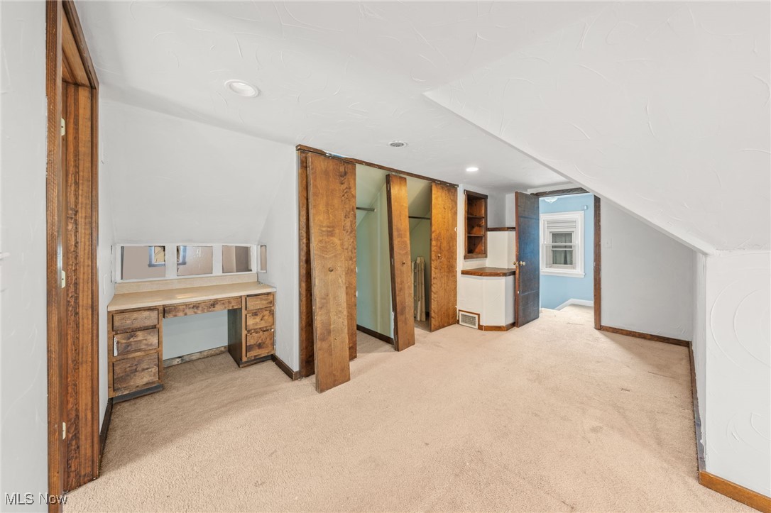 4146 Wyncote Road South Euclid, OH 44121 - Photo 18 of 20 Additional living space with light colored carpet, lofted ceiling, with primary bathroom