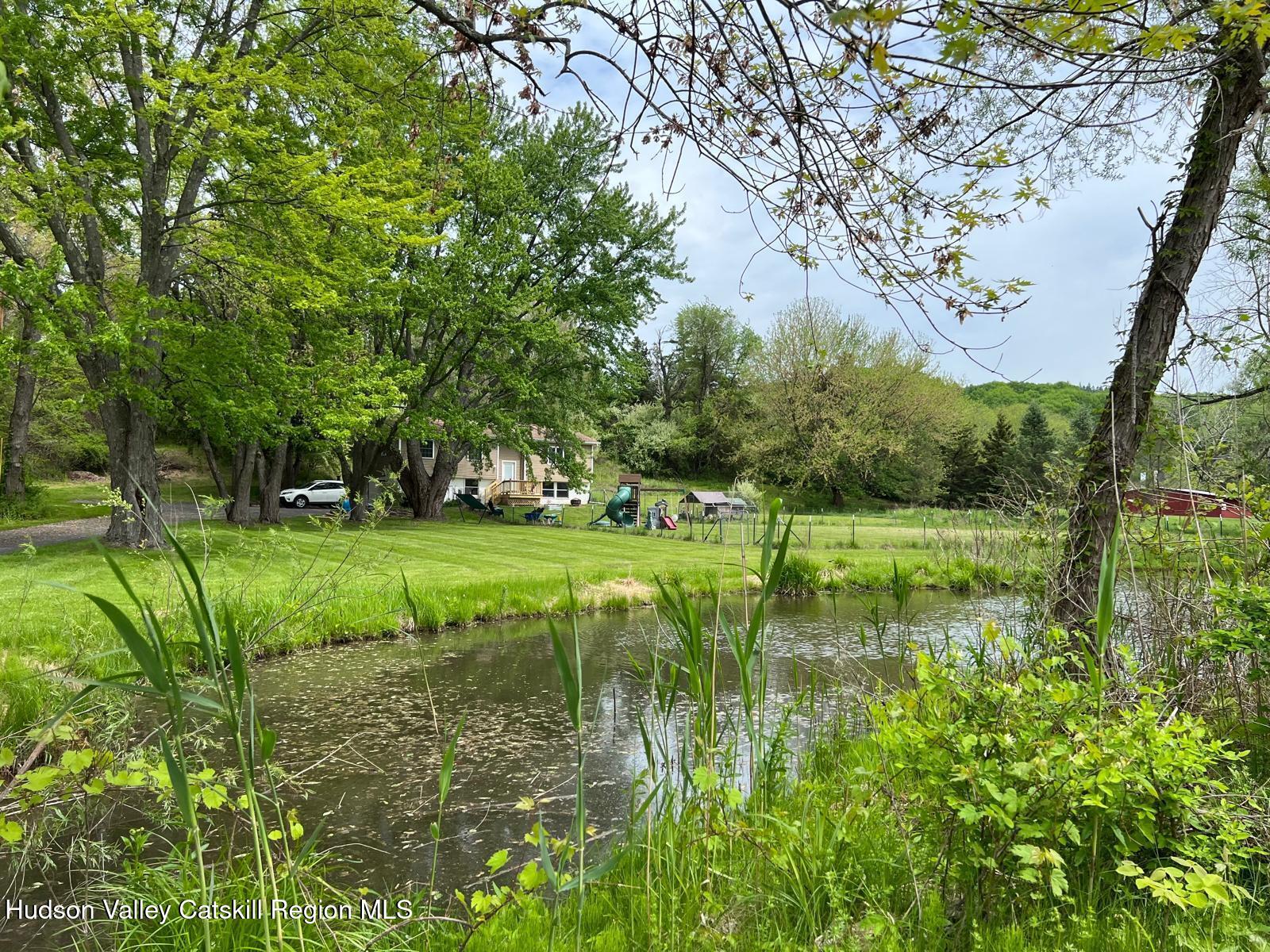 2226 County Rte 27 Hudson, NY 12534 - Photo 2 of 30 a view of a golf course with a lake