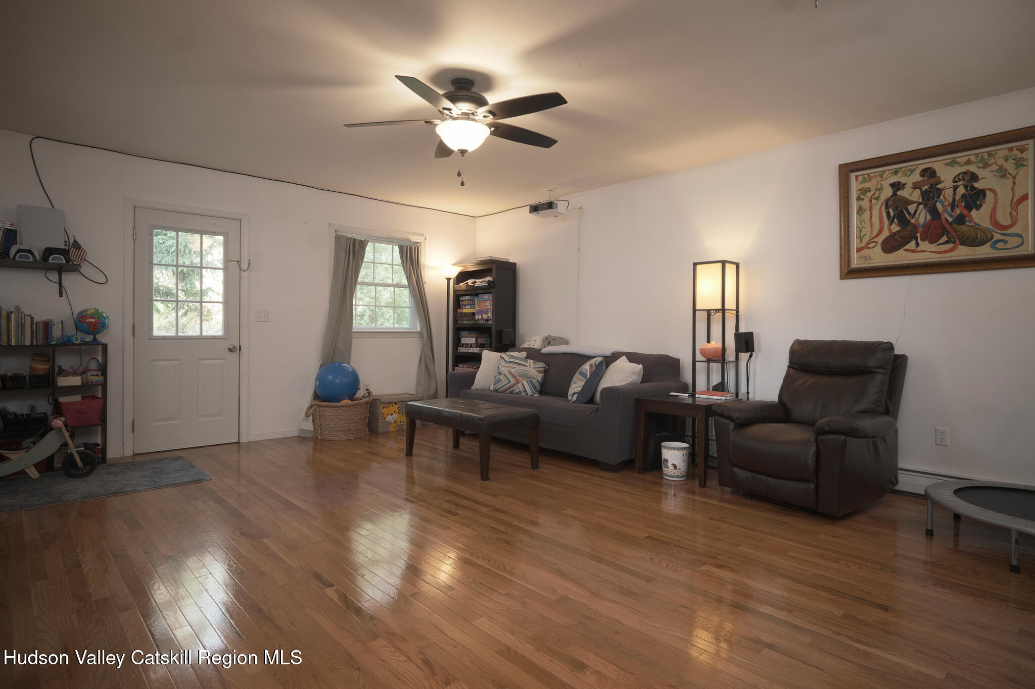 2226 County Rte 27 Hudson, NY 12534 - Photo 8 of 30 a living room with furniture a dining table and a fireplace