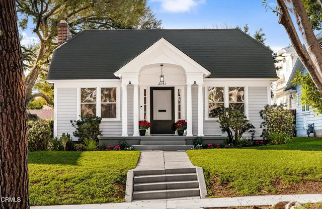 a front view of a house with garden