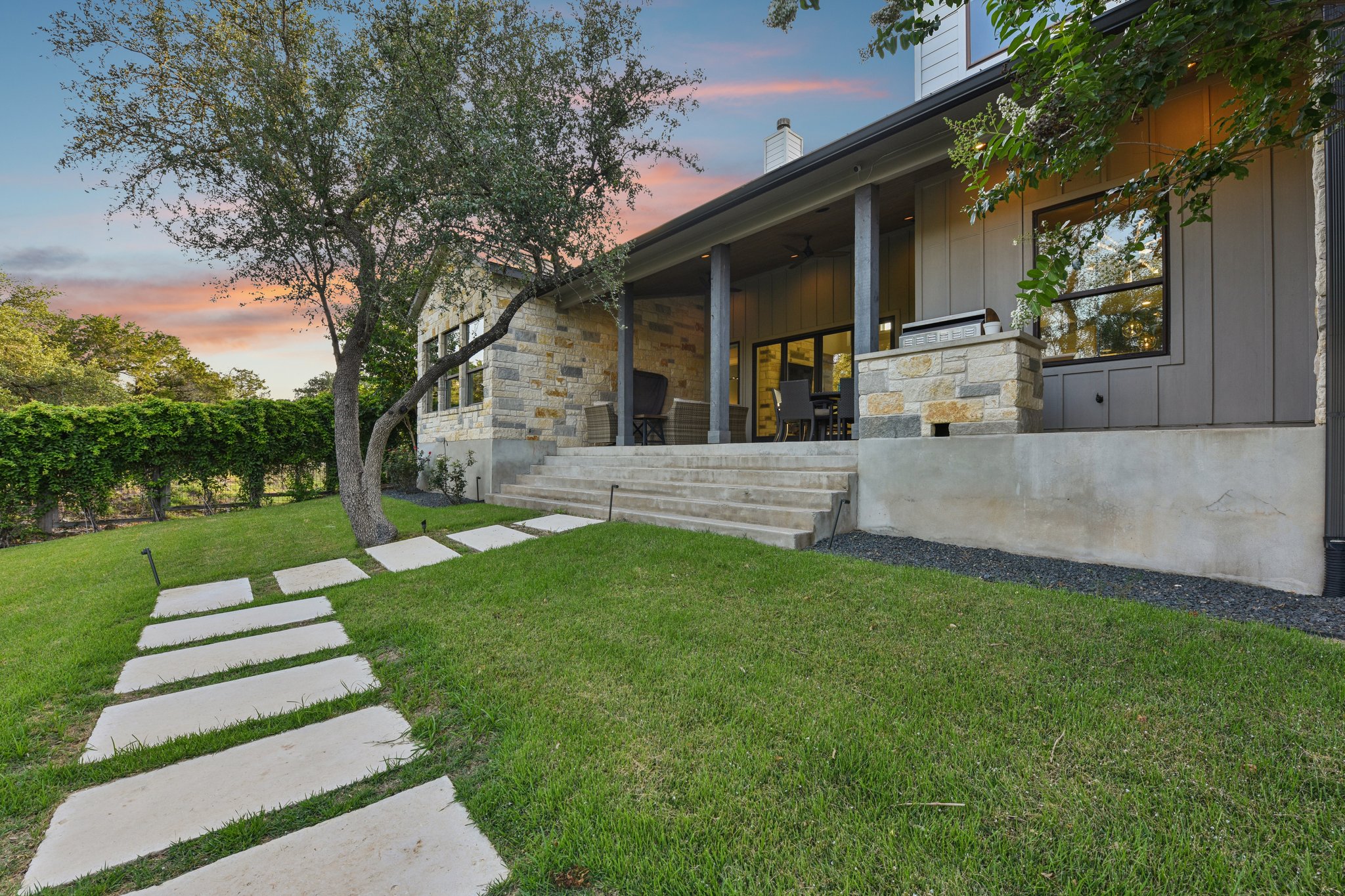 2203 Improver Road Spicewood, TX 78669 - Photo 29 of 38 An inviting stone patio offers a perfect setting for outdoor gatherings, complemented by a serene pathway.
