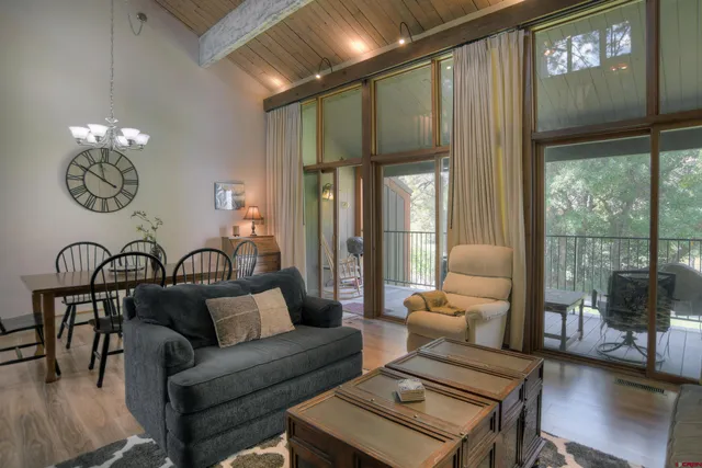 a living room with furniture and a floor to ceiling window