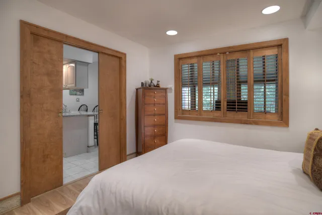 a bedroom with a bed and a large window